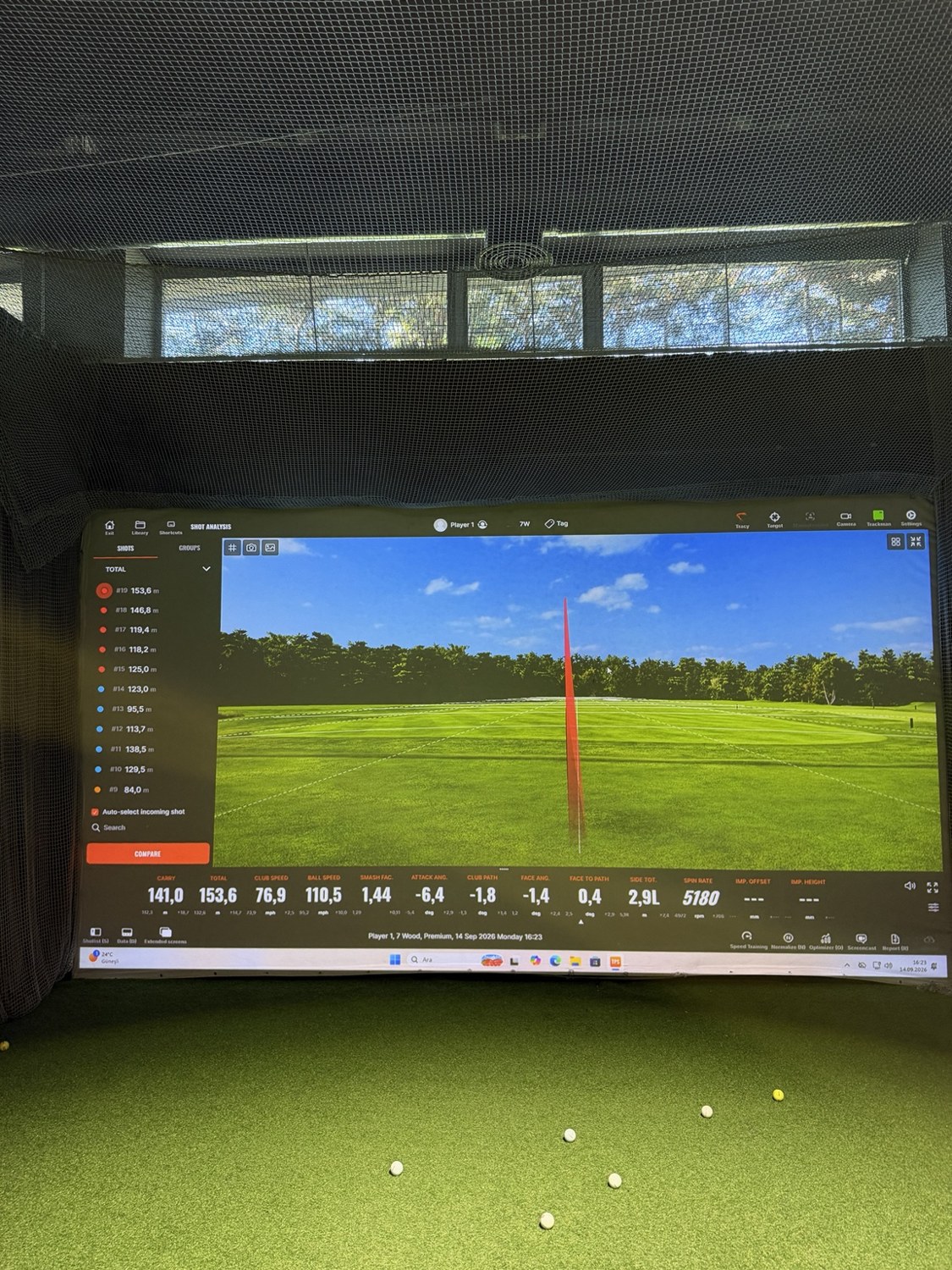 Indoor TrackMan golf simulator displaying ball flight and swing analysis